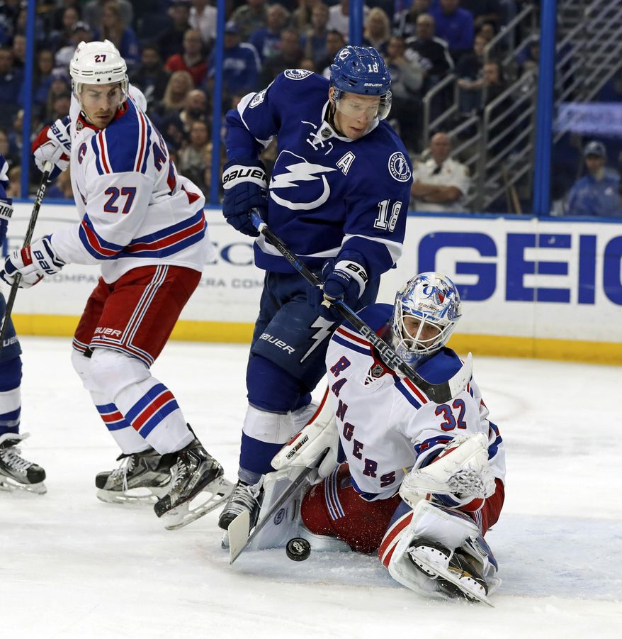 New York Rangers goalie Antti Raanta, of Finland, makes a save against Tampa Bay Lightning&#39;s Ondrej Palat, of the Czech Republic as Ryan McDonagh looks on during the second period of an NHL hockey game, Monday, March 6, 2017, in Tampa, Fla. (AP Photo/Mike Carlson)
