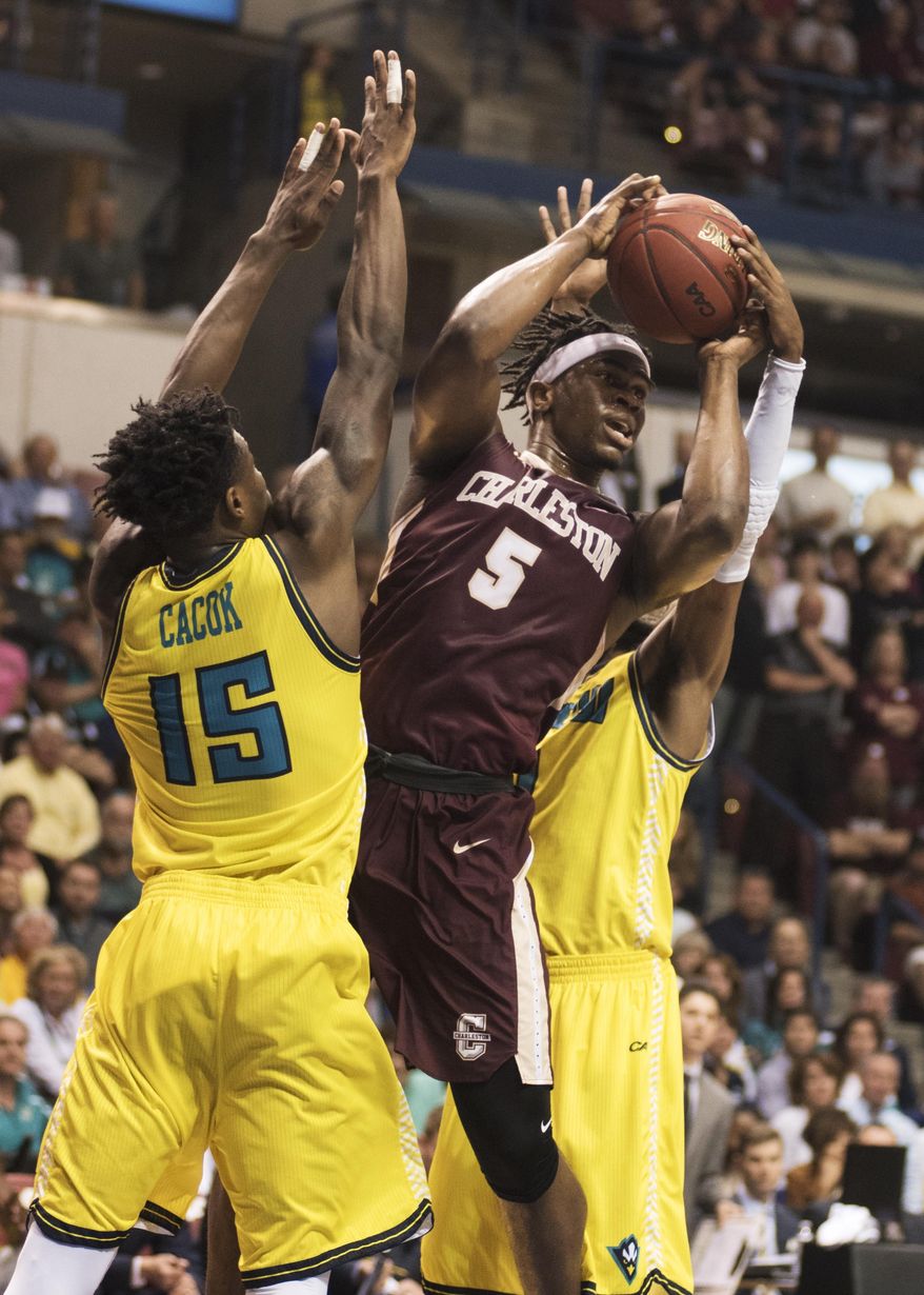 College of Charleston's Jarrell Brantley drives to the net between UNCW's Devontae Cacok and Chris Flemmings during the first half of an NCAA college basketball game in Charleston, S.C., Monday, March 6, 2017. (AP Photo/Mike Spencer)