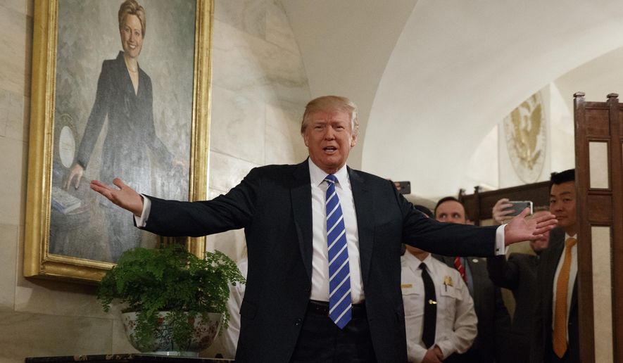 President Trump greets visitors touring the White House in Washington, Tuesday, March 7, 2017. The president greeted the first wave of tourists to come through the White House since he assumed office, welcoming a small crowd of visitors in the East Wing, waving from behind a velvet rope as the crowd screamed, cheered and took photos. (AP Photo/Evan Vucci)