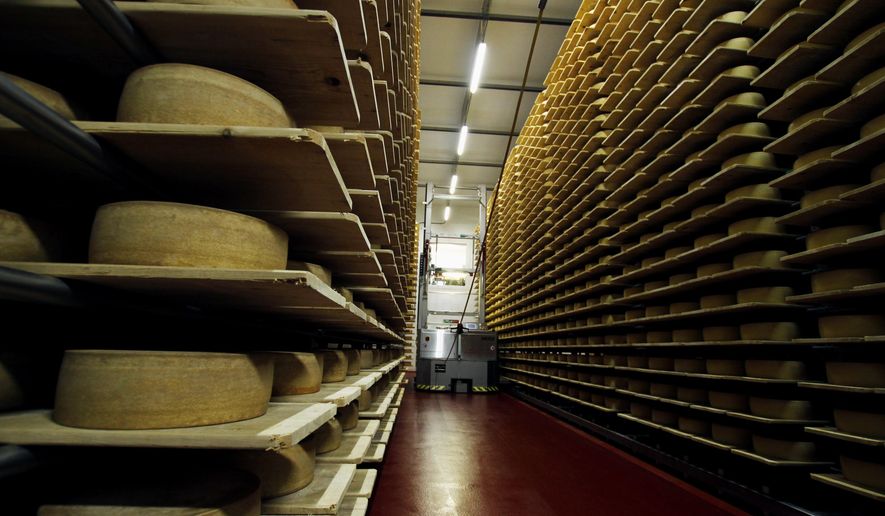 In this Feb. 27, 2017, photo, wheels of Grand Cru Surchoix cheese sit on spruce planks to age for nine months at the Emmi Roth USA production plant in Monroe, Wis. The company won the World Championship Cheese Contest in 2016 for the cheese and since then has seen an increase in sales of the cheese. The contest is organized by the Wisconsin Cheese Makers Association, which also organizes the United States Championship Cheese Contest that runs until March 9 in Green Bay, Wis. The contests are in alternate years. (AP Photo/Carrie Antlfinger)