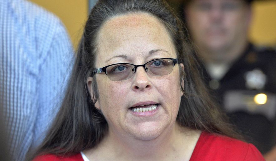 FILE - In this Sept. 14, 2015, file photo, Rowan County Clerk Kim Davis makes a statement to the media at the front door of the Rowan County Judicial Center in Morehead, Ky. U.S. Magistrate Judge Edward B. Atkins ruled Monday, March 6, 2017, that Davis, who refused to issue marriage licenses to same-sex couples in 2015, doesn’t have to pay legal fees for the couples who sued her. (AP Photo/Timothy D. Easley, File)