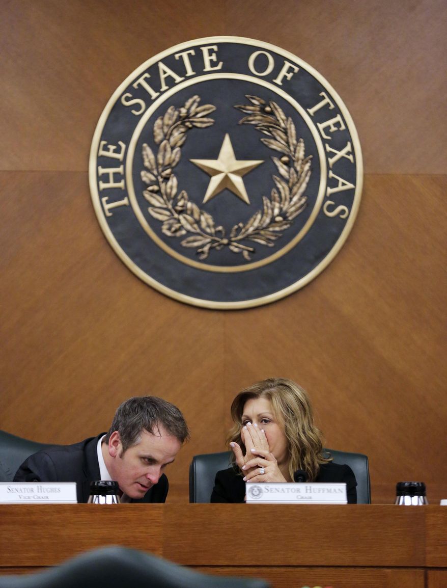 Texas Sen. Bryan Hughes, R-Mineola, and Sen. Joan Huffman, R-Houston, talk as the Senate State Affairs Committee begins debate Senate Bill 6 at the Texas Capitol, Tuesday, March 7, 2017, in Austin, Texas. The the transgender "bathroom bill" would require people to use public bathrooms and restrooms that correspond with the sex on their birth certificate. (AP Photo/Eric Gay)