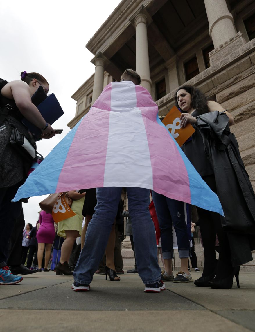 Members of the transgender community take part in a rally on the steps of the Texas Capitol, Monday, March 6, 2017, in Austin, Texas. The group is opposing a "bathroom bill" that would require people to use public bathrooms and restrooms that correspond with the sex on their birth certificate. (AP Photo/Eric Gay)