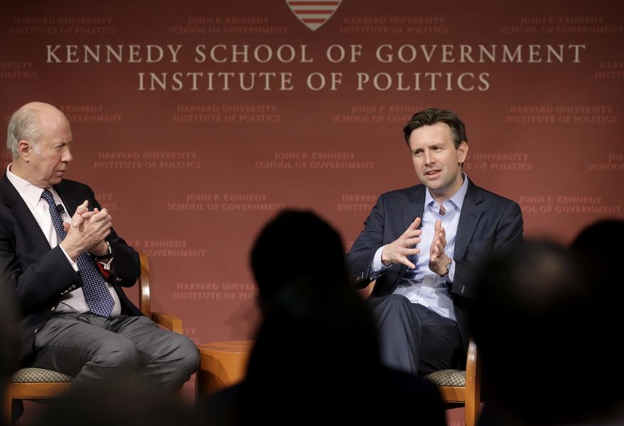 Former Obama White House press secretary Josh Earnest, right, participates in a forum called "The Press & the Presidency," as Harvard professor and former presidential advisor David Gergen, left, looks on, Tuesday, March 7, 2017, at the John F. Kennedy School of Government on the campus of Harvard University, in Cambridge, Mass. Earnest has accused President Donald Trump of using wiretapping allegations as a distraction. (AP Photo/Steven Senne)