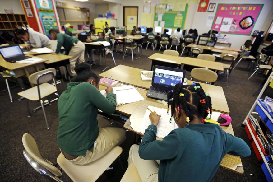In this Feb. 23, 2017 photo, students work on a project in teacher Annika Edgerson's third-grade classroom at the Martin Luther King Jr. Elementary School in Hartford, Conn. Traditional public schools still educate about half the city’s children, but they are not moving in the same direction as magnet schools with racial integration and academic achievement. (AP Photo/Elise Amendola)