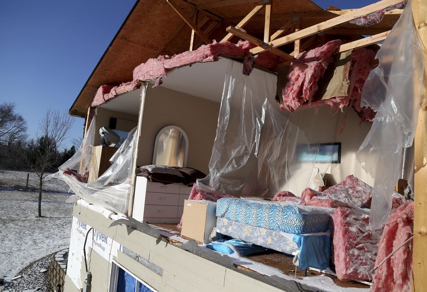 A side of a house is destroyed from a storm Monday evening is shown in Orrock Township near Zimmerman, Minn., on Tuesday, March 7, 2017,. Weather experts say a likely tornado touched down northwest of the Twin Cities, taking down trees and power lines and damaging buildings. (David Joles /Star Tribune via AP)