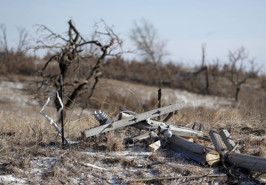 A downed power pole from a storm Monday evening is scattered on the ground, Tuesday, March 7, 2017, in Orrock Township near Zimmerman, Minn. Weather experts say a likely tornado touched down northwest of the Twin Cities, taking down trees and power lines and damaging buildings. (David Joles /Star Tribune via AP)