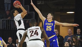 Omaha&#39;s Daniel Norl (13) takes a shot as South Dakota State&#39;s Lane Severyn (25) defends during the Summit League NCAA college basketball championship game, Tuesday, March 7, 2017, at the Denny Sanford Premier Center in Sioux Falls, S.D. (Joe Ahlquist/Argus Leader via AP)