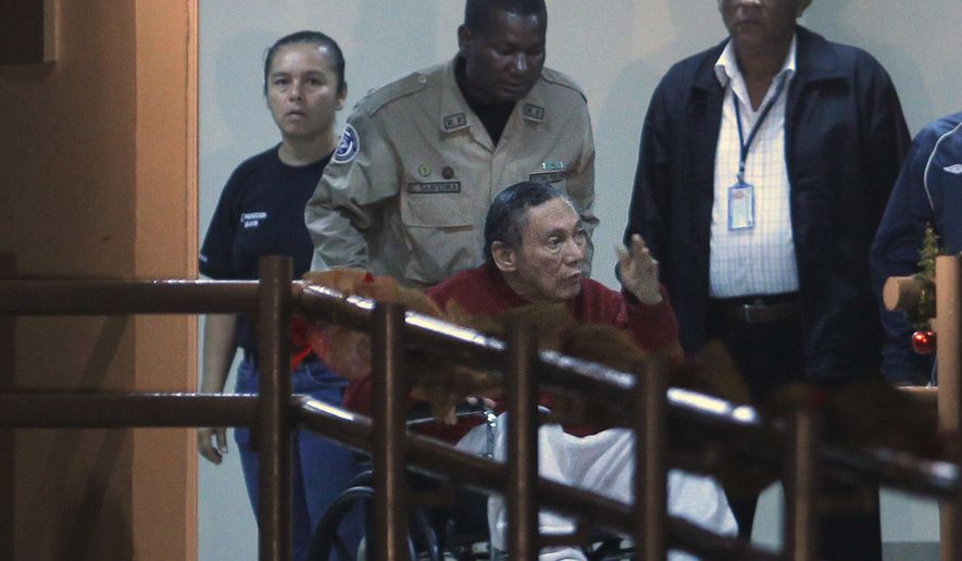 In this Dec. 11, 2011, file photo, Panama&#39;s ex-dictator Manuel Noriega is pushed in a wheelchair by a police officer inside El Renacer prison on the outskirts of Panama City. Noriega, 83, is in critical condition after undergoing two brain surgeries Tuesday, March 7, 2017. Noriega underwent the first procedure Tuesday morning to remove a benign tumor from his brain. But after that surgery, doctors discovered a hemorrhage that forced them to go back in that afternoon, his daughters and lawyer said. (AP Photo/Esteban Felix, File)