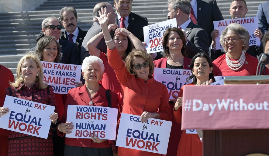 House Minority Leader Nancy Pelosi of Calif., waves her hand as she is recognized during an event on Capitol Hill in Washington, Wednesday, March 8, 2017, to honor International Women's Day. (AP Photo/Susan Walsh)