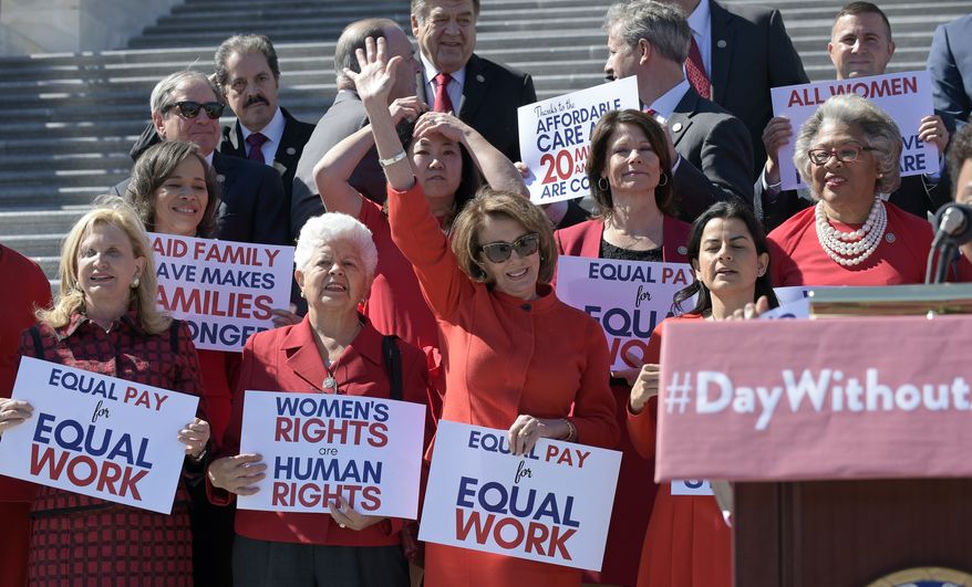 House Minority Leader Nancy Pelosi of Calif., waves her hand as she is recognized during an event on Capitol Hill in Washington, Wednesday, March 8, 2017, to honor International Women's Day. (AP Photo/Susan Walsh)