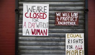 Signs are posted at the Grindcore House restaurant shuttered in solidarity with &quot;A Day Without a Woman&quot; in Philadelphia, Wednesday, March 8, 2017. Organizers of January&#39;s Women&#39;s March are calling on women to stay home from work and not spend money in stores or online to show their impact on American society. (AP Photo/Matt Rourke)