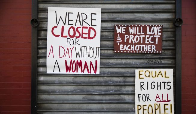 Signs are posted at the Grindcore House restaurant shuttered in solidarity with &quot;A Day Without a Woman&quot; in Philadelphia, Wednesday, March 8, 2017. Organizers of January&#x27;s Women&#x27;s March are calling on women to stay home from work and not spend money in stores or online to show their impact on American society. (AP Photo/Matt Rourke)