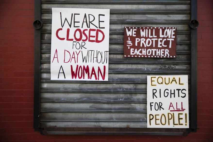 Signs are posted at the Grindcore House restaurant shuttered in solidarity with "A Day Without a Woman" in Philadelphia, Wednesday, March 8, 2017. Organizers of January's Women's March are calling on women to stay home from work and not spend money in stores or online to show their impact on American society. (AP Photo/Matt Rourke)