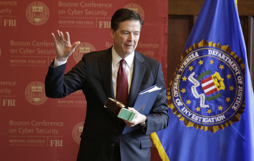 FBI Director James Comey acknowledges applause as he leaves after speaking on cyber security at the first Boston Conference of Cyber Security at Boston College, Wednesday, March 8, 2017, in Boston. (AP Photo/Stephan Savoia)