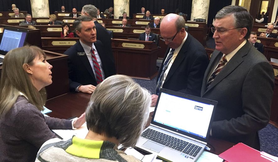 Idaho state House Speaker Scott Bedke, R-Oakley, right, speaks to legislative leaders and staff about proper floor procedures on the House floor in Boise, Idaho on Wednesday, March 8, 2017. The Idaho House came to a grinding halt Wednesday for the second time this week after members attempted to force the body's hand to vote on a previously blocked bill. (AP Photo/Kimberlee Kruesi)