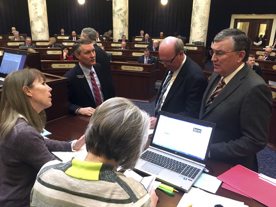 Idaho state House Speaker Scott Bedke, R-Oakley, right, speaks to legislative leaders and staff about proper floor procedures on the House floor in Boise, Idaho on Wednesday, March 8, 2017. The Idaho House came to a grinding halt Wednesday for the second time this week after members attempted to force the body's hand to vote on a previously blocked bill. (AP Photo/Kimberlee Kruesi)