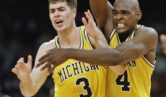 FILE - In this April 3, 1993 file photo, Michigan&#39;s Chris Webber (4) and Rob Pelinka (3) celebrate in New Orleans as they defeated Kentucky 81-78 in overtime to advance to the NCAA college basketball championship game against North Carolina. Longtime sports agent Rob Pelinka, whose clients included Kobe Bryant, was formally named the Los Angeles Lakers&#39; new general manager Tuesday, March 7, 2017. (AP Photo/Ed Reinke, File)