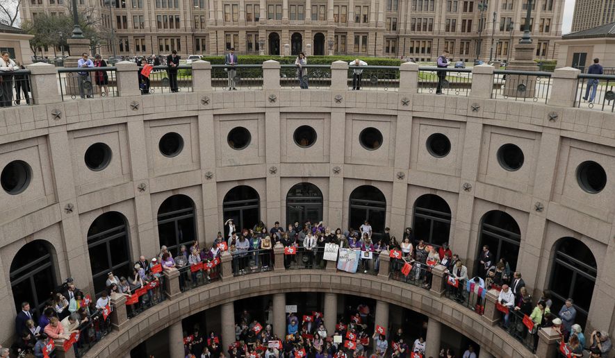 Members of the transgender community and others who oppose Senate Bill 6 protest in the exterior rotunda at the Texas Capitol as the Senate State Affairs Committee holds hearings on the bill, Tuesday, March 7, 2017, in Austin, Texas. The transgender "bathroom bill" would require people to use public bathrooms and restrooms that correspond with the sex on their birth certificate. (AP Photo/Eric Gay)
