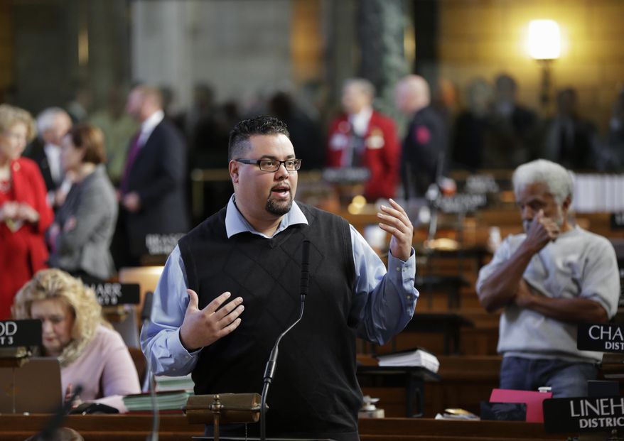 Sen. Justin Wayne of Omaha, a criminal defense attorney who has represented drug offenders, speaks in Lincoln, Neb., Wednesday, March 8, 2017, during a debate on a compromise bill that would eliminate mandatory minimum sentences for drug offenders. Nebraska lawmakers have reached a compromise that would eliminate mandatory minimum sentences for cocaine, heroin and meth dealers. Senators voted 25-22 to advance the measure. (AP Photo/Nati Harnik)