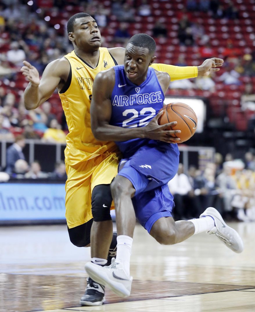Air Force&#39;s Pervis Louder, right, drives to the basket as Wyoming&#39;s Louis Adams defends during the second half of an NCAA college basketball game in the Mountain West Conference tournament Wednesday, March 8, 2017, in Las Vegas. Air Force defeated Wyoming 83-68. (AP Photo/Isaac Brekken)
