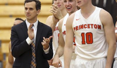 FILE - In this Nov. 25, 2016, file photo, Princeton coach Mitch Henderson applauds as he stands with his players during the second half of an NCAA college basketball game against Rowan in Princeton, N.J. As the first team to go 14-0 in Ivy League play and not automatically qualify for the NCAA Tournament, Princeton has earned a somewhat dubious distinction in league history. Were it any previous year, the Tigers would be eagerly awaiting Selection Sunday. However, the Ivy became the nation’s final league to employ a conference tournament to decide its automatic qualifier, so Princeton (21-6) still needs two wins in Philadelphia this weekend to reach the NCAAs. (AP Photo/Mel Evans, File)