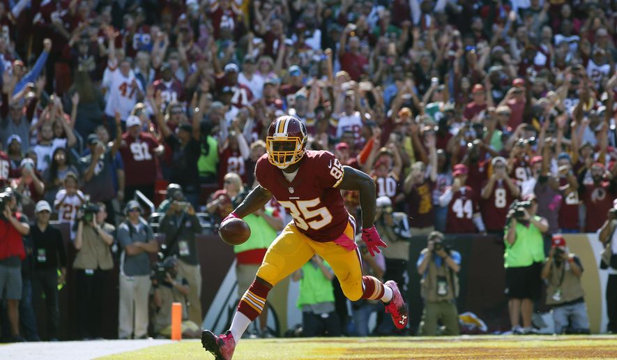 FILE - In this Oct. 16, 2016, file photo, Washington Redskins tight end Vernon Davis scores a touchdown in the first half of an NFL football game against the Philadelphia Eagles in Landover, Md. The Redskins have re-signed tight end Vernon Davis.According to Davis’ Snapchat, it’s a three-year deal. The team announced the contract early Wednesday morning, March 8, 2017. (AP Photo/Alex Brandon, File)