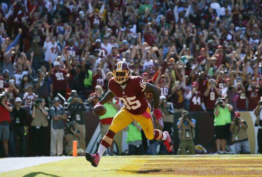FILE - In this Oct. 16, 2016, file photo, Washington Redskins tight end Vernon Davis scores a touchdown in the first half of an NFL football game against the Philadelphia Eagles in Landover, Md. The Redskins have re-signed tight end Vernon Davis.According to Davis’ Snapchat, it’s a three-year deal. The team announced the contract early Wednesday morning, March 8, 2017. (AP Photo/Alex Brandon, File)