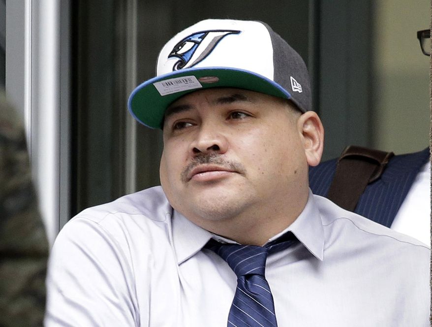 FILE -- In this Jan. 11, 2016, file photo, Raymond Fryberg exits U.S. District Court after his sentencing in Seattle. Fryberg, the father of a teenager who used his gun to kill four classmates and then himself at a Washington state high school, was sentenced to two years in prison on firearms charges. The lawyer for Fryberg asked a federal appeals court Wednesday, March 8, 2017, to throw out the conviction for illegally possessing the gun used in the crime. (AP Photo/Elaine Thompson, File)