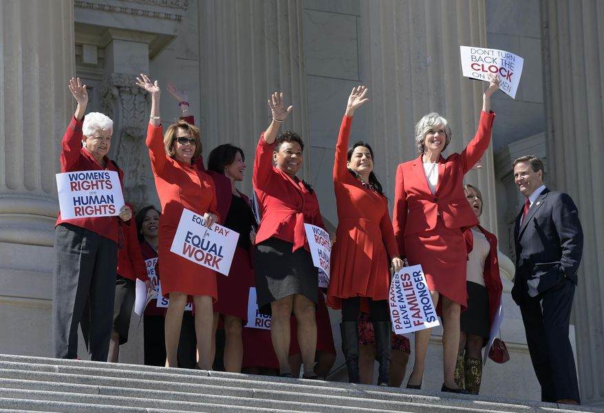 House Minority Leader Nancy Pelosi of Calif., second from left, joined by fellow Democratic House members, wave from the top of the steps of Capitol Hill in Washington, Wednesday, March 8, 2017, during an event for International Women's Day. (AP Photo/Susan Walsh)
