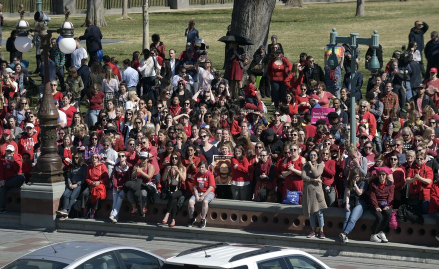People gather and listen as House Minority Leader Nancy Pelosi of Calif., joined other female Representatives, speak during an event on Capitol Hill in Washington, Wednesday, March 8, 2017, for International Women's Day. (AP Photo/Susan Walsh)