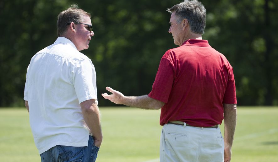Washington Redskins general manager Scot McCloughan, left, talks with team president Bruce Allen during an NFL football organized team activity at Redskins Park, on Tuesday, May 26, 2015, in Ashburn, Va. (AP Photo/Evan Vucci)
