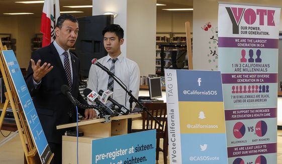 California Secretary of State Alex Padilla, left, joins student Albert Min, for the launch of the California Online Pre-Registration for 16 and 17 Year Olds at Robert F. Kennedy High School in Los Angeles Thursday, March 9, 2017. California youth who pre-register to vote will have their registration become active once they turn 18 years old. Eligible youth can pre-register to vote online at www.registertovote.ca.gov. (AP Photo/Damian Dovarganes)