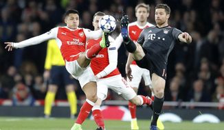 Arsenal&#39;s Alexis Sanchez, left, and Bayern&#39;s Xabi Alonso battle for the ball during the Champions League round of 16 second leg soccer match between Arsenal and Bayern Munich at the Emirates Stadium in London, Tuesday, March 7, 2017. (AP Photo/Frank Augstein)