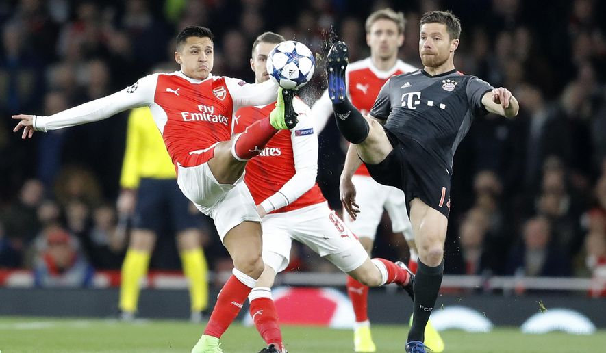 Arsenal&#x27;s Alexis Sanchez, left, and Bayern&#x27;s Xabi Alonso battle for the ball during the Champions League round of 16 second leg soccer match between Arsenal and Bayern Munich at the Emirates Stadium in London, Tuesday, March 7, 2017. (AP Photo/Frank Augstein)