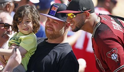 Arizona Diamondbacks right fielder David Peralta, right, poses for a picture with some fans prior to a spring training baseball game against the Chicago White Sox, Thursday, March 9, 2017, in Glendale, Ariz. (AP Photo/Ross D. Franklin)