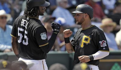 Pittsburgh Pirates&#x27; Danny Ortiz, right, high fives on-deck batter Josh Bell after scoring on a ground out by Alen Hanson during the second inning of an exhibition baseball game against the Dominican Republic Wednesday, March 8, 2017, in Bradenton, Fla. (AP Photo/Chris O&#x27;Meara)