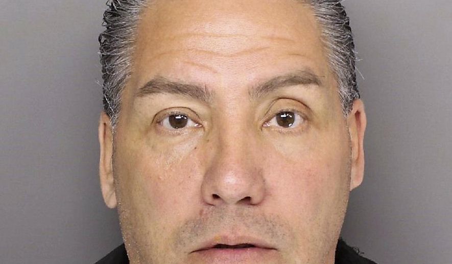 This March 3, 2017 photo provided by Greenville, S.C., police shows Michael Ruiz in Greenville after his arrest on human trafficking charges, including posing as an ICE agent and swindling immigrants out of more than $70,000. Ruiz is among the con artists across the country are taking advantage of a climate of fear among immigrants by posing as federal agents and ordering them pay up or else be detained and deported, authorities and outreach groups say. (Greenville, SC Police Dept. via AP)
