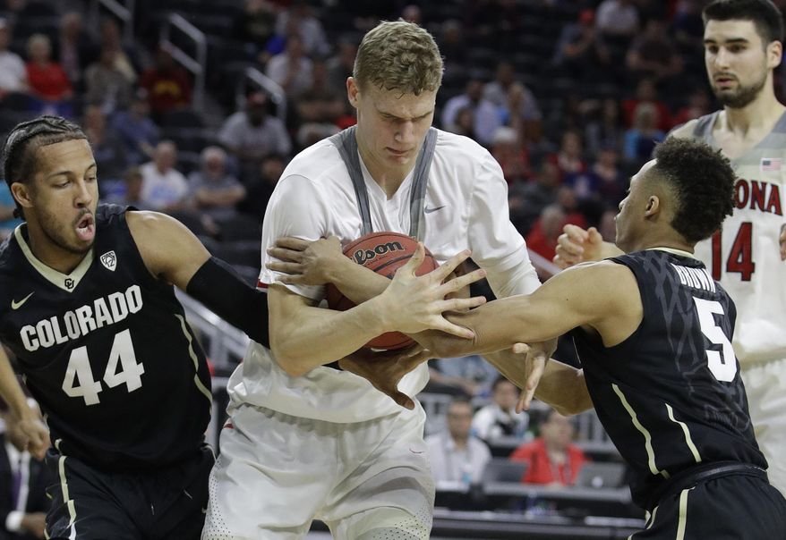 Arizona's Lauri Markkanen, center, struggles for the ball with Colorado's Josh Fortune, left, and Deleon Brown during the first half of an NCAA college basketball game in the quarterfinals of the Pac-12 men's tournament Thursday, March 9, 2017, in Las Vegas. (AP Photo/John Locher)
