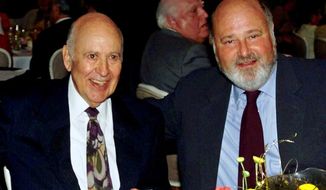 FILE - In this Aug. 18, 2000 file photo, Carl Reiner, left, appears with his son Rob Reiner at a Friars Club of California dinner in his honor in Beverly Hills, Calif. The Reiners are set to make history at the TCL Chinese Theatre, becoming the first father and son to jointly leave their cement footprints outside the Hollywood landmark on April 7, 2017.  (AP Photo/Reed Saxon, File)