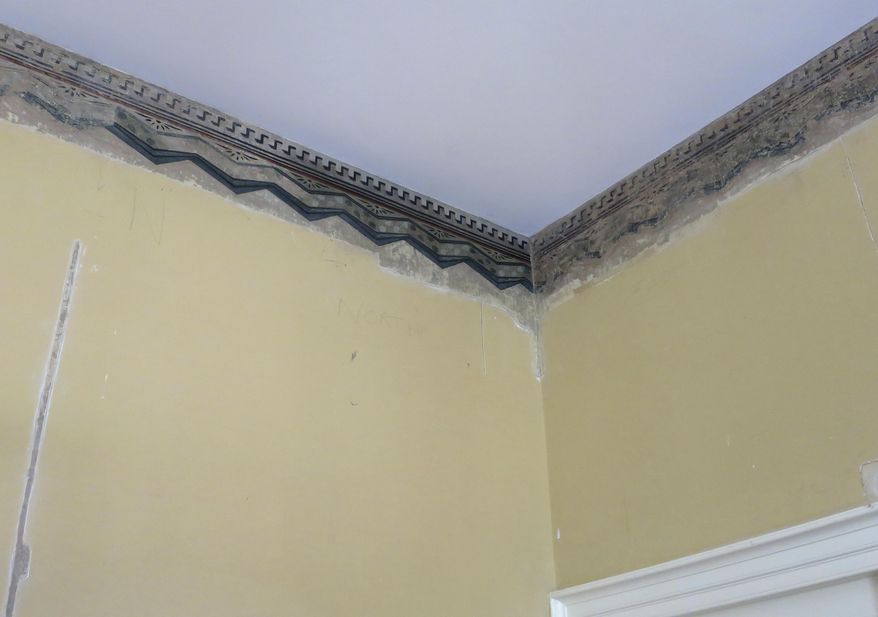 This Aug. 20, 2016 photo shows a detail of a decorative wall border being restored at the home of artist Thomas Cole, in Catskill, N.Y. Not only did Cole paint the lush mountain landscapes that inspired the Hudson River School art movement of the 19th century, he also painted pretty decorative patterns on the walls in the parlor of his Catskill home that had been buried beneath layers of paint for more than a century before they were discovered a few years ago. Now curators have painstakingly revealed the stylized depictions of drapery and fabric so they can be displayed when the Thomas Cole National Historic Site opens for the season in May 2017. (AP Photo/Barbara Woike)