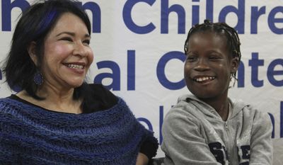 Elissa Montanti, left, of the Global Medical Relief Fund, smiles with Janet Sylva during a press conference at Cohen Children&#39;s Medical Center in New Hyde Park, N.Y., on Thursday, March 9, 2017. Surgeons removed a 6-pound tumor that had been growing in the 12-year-old girl&#39;s mouth during a procedure at the medical center in January. The girl and her mother, who are from the West African nation of Gambia, were brought to the United States for the free surgery by the The Global Medical Relief Fund. (AP Photo/Frank Eltman)