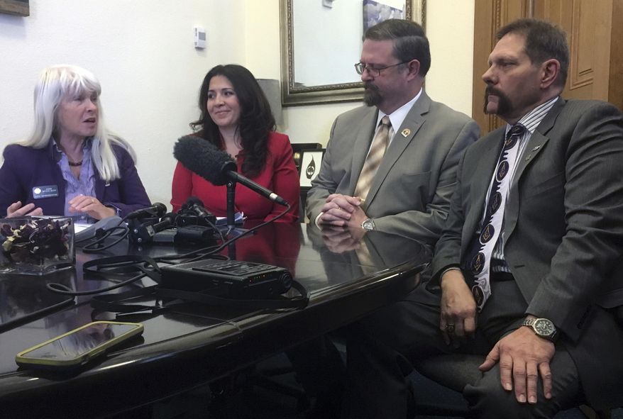 Democratic Rep. Diane Mitsch Busch, left with Democratic House Speaker Crisanta Duran, second from left, and Republican Senate President Kevin Granthamm second from right, and Republican Sen. Randy Baumgartner, right, discuss a bipartisan transportation funding bill at the state Capitol in Denver on Thursday, March 9, 2017. Their bill would ask voters to approve a state sales tax hike and $3.5 million in bonds to fund roads and other transit needs over the next 20 years. (AP Photo/Jim Anderson)