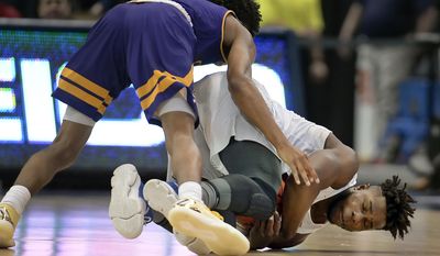 SMU's Semi Ojeleye dives for a loose ball as East Carolina's Jeremy Sheppard, top, defends, during the first half of an NCAA college basketball game in the American Athletic Conference tournament quarterfinals, Friday, March 10, 2017, in Hartford, Conn. (AP Photo/Jessica Hill)