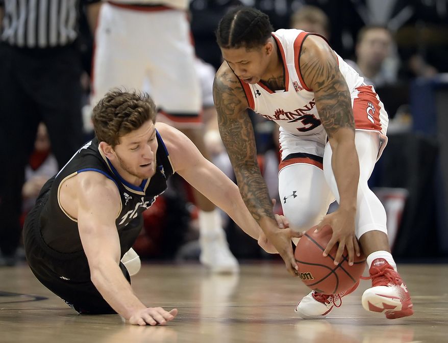 Tulsa&#39;s Will Magnay, left, and Cincinnati&#39;s Justin Jenifer, right, chase a loose ball during the second half of an NCAA college basketball game in the American Athletic Conference tournament quarterfinals, Friday, March 10, 2017, in Hartford, Conn. (AP Photo/Jessica Hill)