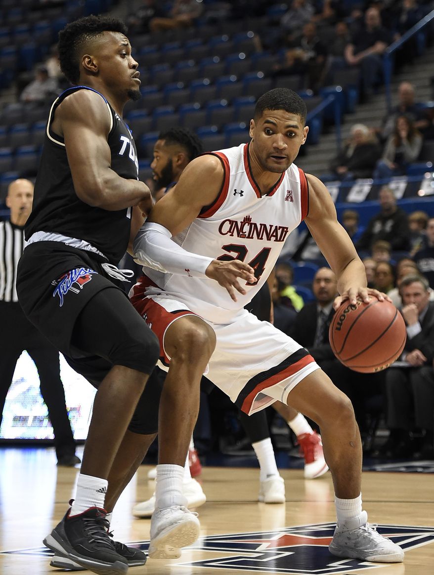 Cincinnati&#39;s Kyle Washington dribbles around Tulsa&#39;s Martins Igbanu, left, during the first half of an NCAA college basketball game in the American Athletic Conference tournament quarterfinals, Friday, March 10, 2017, in Hartford, Conn. (AP Photo/Jessica Hill)