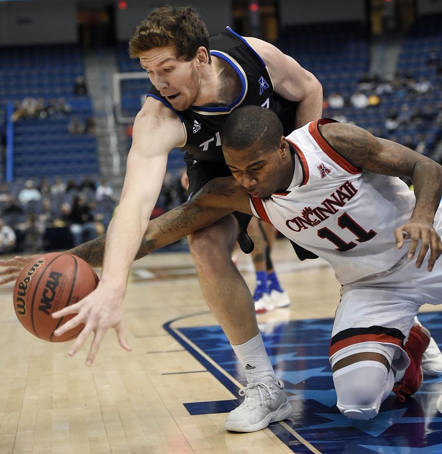 Tulsa&#39;s Will Magnay, top and Cincinnati&#39;s Gary Clark reach for a loose ball during the first half of an NCAA college basketball game in the American Athletic Conference tournament quarterfinals, Friday, March 10, 2017, in Hartford, Conn. (AP Photo/Jessica Hill)