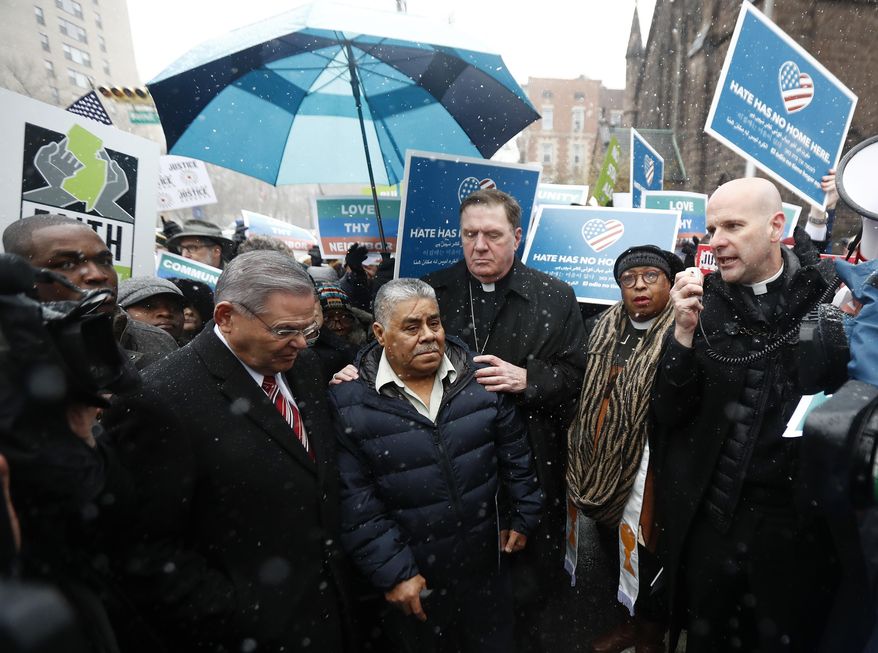 Catalino Guerrero, center left, stands with U.S. Sen. Bob Menendez, left, and Newark Archbishop Cardinal Joseph Tobin, center right, during a rally outside of the Peter Rodino Federal Building before attending an immigration hearing, Friday, March 10, 2017, in Newark, N.J. Guerrero, who arrived in the U.S. illegally in 1991, is facing deportation. Organizers claim he is an upstanding citizen and should not be deported. (AP Photo/Julio Cortez)