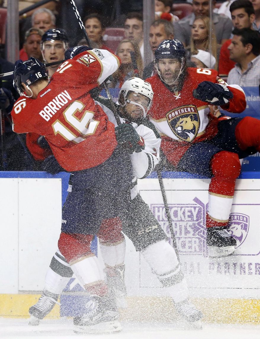 Florida Panthers center Aleksander Barkov (16) slams Minnesota Wild defenseman Matt Dumba (24) into the boards during the second period of an NHL hockey game, Friday, March 10, 2017, in Sunrise, Fla. (AP Photo/Wilfredo Lee)