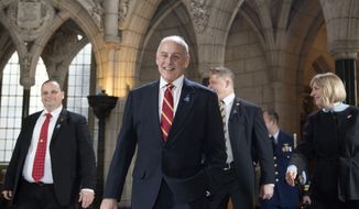 U.S. Secretary of Homeland Security John Kelly, centre, walks through the Rotunda in Centre Block as he leaves Parliament Hill after a day of bilateral meetings with multiple Canadian ministers on Friday, March 10, 2017 in Ottawa. (Justin Tang/The Canadian Press via AP)